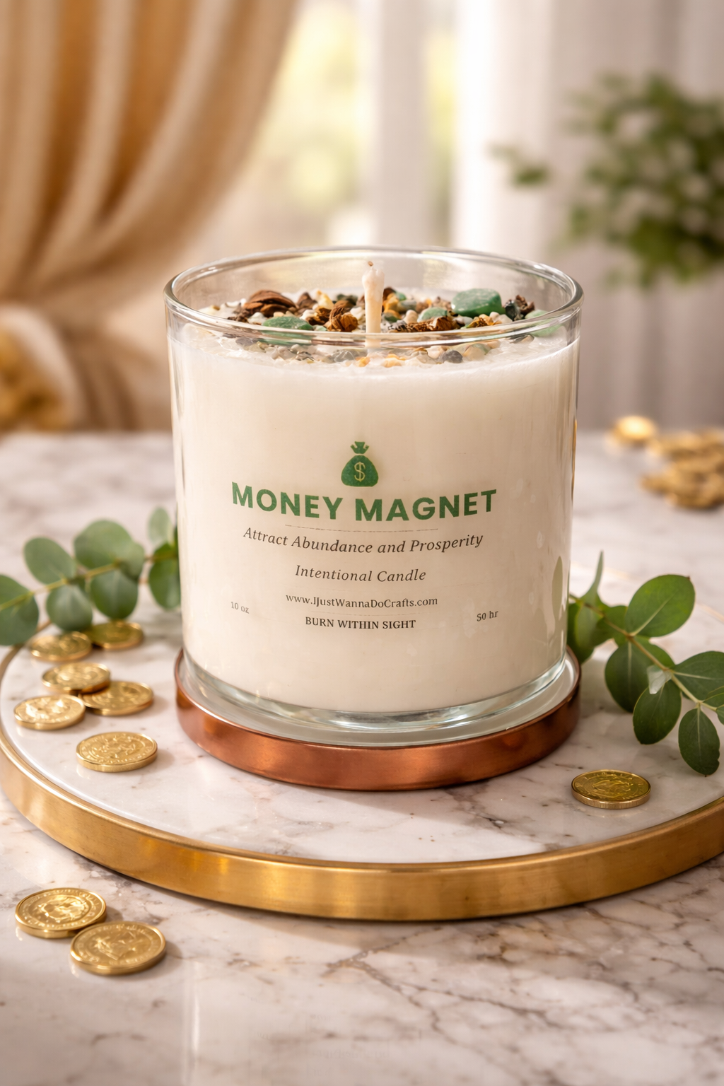 Money Magnet candle on a marble surface with gold coins and greenery