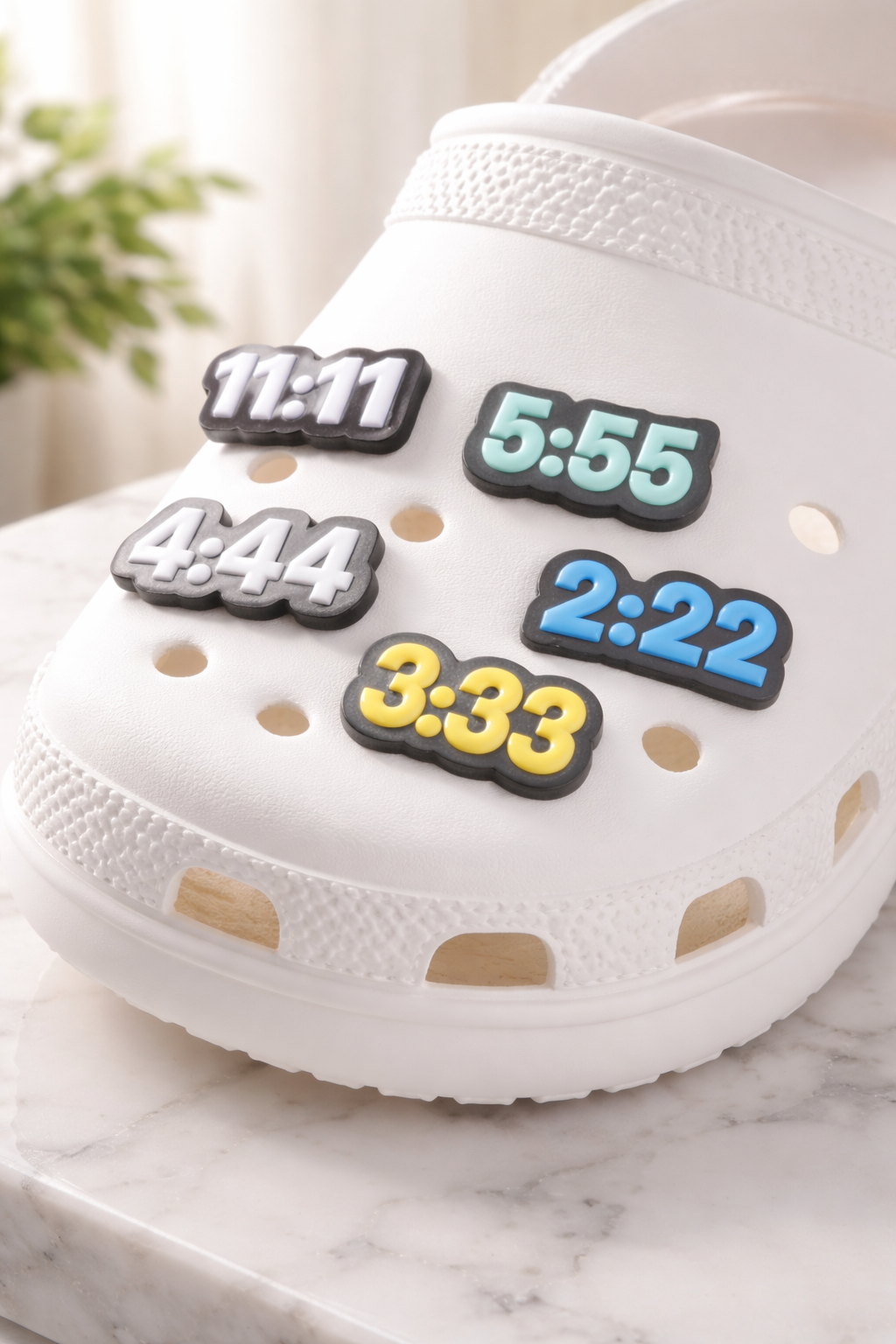 Numerology croc jibbitz charms featuring angel numbers 111, 222, 333, 444, and 555 displayed on white crocs