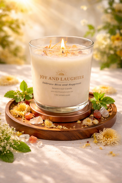 Candle labeled 'Joy and Laughter' in a clear glass jar styled flowers and crystals in warm natural light. 